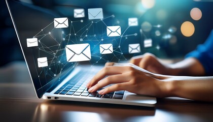 hand types on a laptop with email icons floating around.