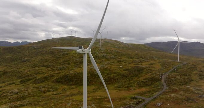 Aerial view of spinning blades of wind turbines on mountain in Sortland, Norway