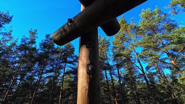 POV view of the blue sky and forest trees around the Bumbu Hill Firewatch Tower in Latvia, sunny, copy space, slow motion