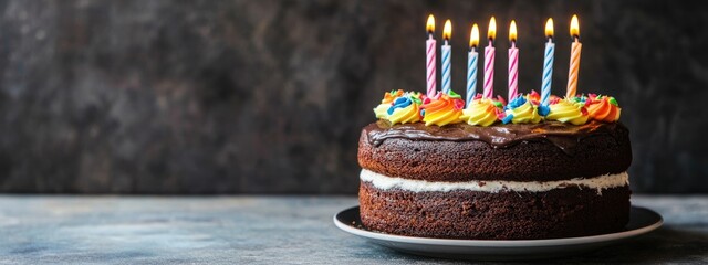 Dog Birthday Cake with Colorful Candles and Empty Copy Space for Personalization on a Rustic Table Background