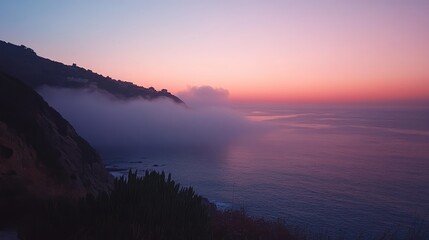 Obraz premium Serene dawn over a calm bay shrouded in dense fog with peaceful water and hillside silhouette creating ample copy space for text.