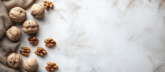 Obraz premium Freshly Cracked Walnuts in Shell and Shelled Nuts on Marble Surface with Empty Space for Text and Culinary Decoration Ideas
