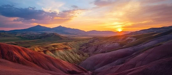 Fototapete Vibrant sunset illuminating Seven Colored Earth landscape with dramatic sky and expansive foreground for text placement © The 2R Artificiality