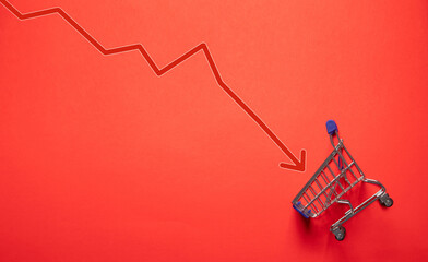 Shopping cart with a down arrow. Drop in sales of a business