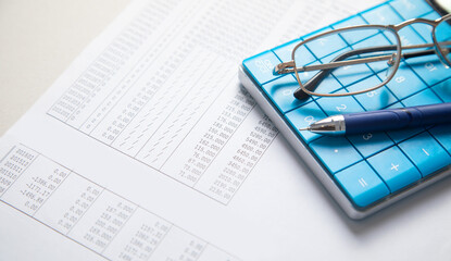 Financial accounting with a calculator and pen. Finance
