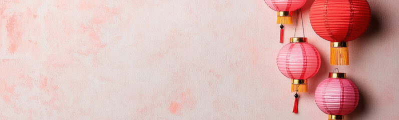 Red and pink lanterns on pastel background symbolize prosperity