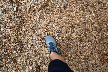 Foot wear sneaker on wooden chips stay wooden small piece