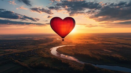 Fototapeta premium A whimsical heart-shaped hot air balloon floating above a scenic countryside at sunset
