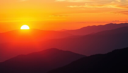 Obraz premium Sunset Over Silhouetted Mountain Ranges A Fiery Sky