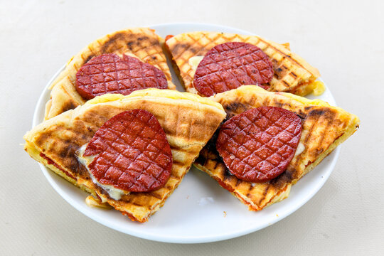 Turkish karisik atom Ayvalik tost ( kasarli bazlama tost) . Sucuklu, Kasarli, kavurmali karisik tost. Flat baked bread toasted. Karisik bazlama tost .  