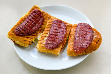 Turkish karisik atom Ayvalik tost ( kasarli bazlama tost) . Sucuklu, Kasarli, kavurmali karisik tost. Flat baked bread toasted. Karisik bazlama tost .  