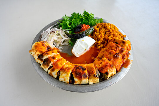 Famous Urfa meat liver, ciger wrapped by lavash with roasted chili pepper, onion and sauce in Sanliurfa, Turkey. Kuzu et ciger sis. Izgara dana bonfile, cop sis, kuzu pirzola. Karisik kebap, beyti keb