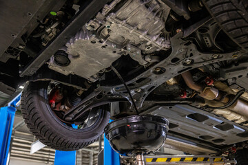 Close-up shot of old car engine oil draining from engine to change new oil at the service center or oil change shop