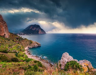 Fototapeta premium Aerial view at sunset over the Mediterranean sea. Location place Island Sicilia, Zafferano cape, Palermo city, Italy, Europe. Scenic image of famous european resort. Discover the beauty of earth.