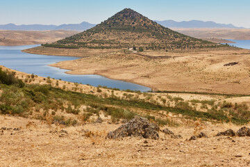 Picturesque hill pyramidal shape huge roundabout and road. Extremadura, Spain