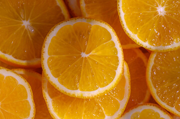 Freshly sliced oranges arranged beautifully under bright sunlight in a vibrant display of color and texture