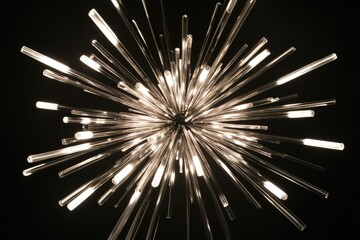 Obraz premium A modern, radiant chandelier with numerous glass rods radiating outwards, creating a firework-like effect.