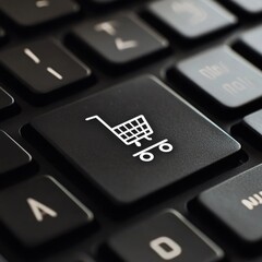 Obraz premium Close-up of a black keyboard key featuring a shopping cart icon, symbolizing online shopping and e-commerce.