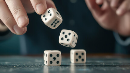 Close-up of fingertips rolling dice on tabletop with blurred background