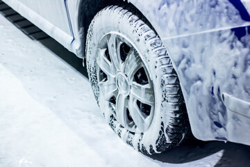 This is a closeup image showcasing a car wheel that is covered in foam
