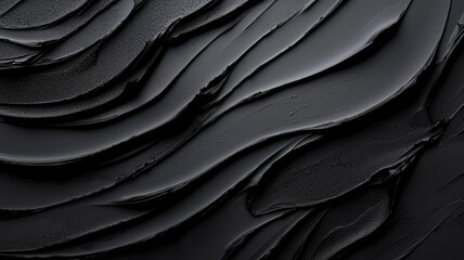 Fototapeta premium Textured black surface with wavy patterns and smooth layers.