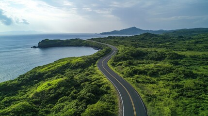 Serpentine Road Meandering Through Lush Coastal Landscape
