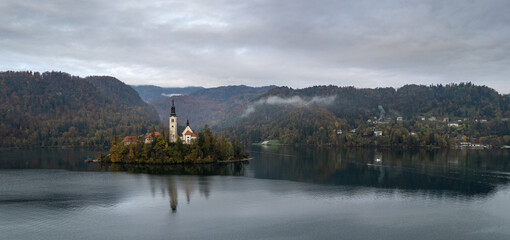Pilgrimage church of the assumption of maria reflecting on lake bled, slovenia