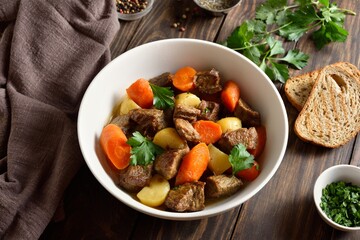 Beef meat stewed with potatoes, carrots and spices