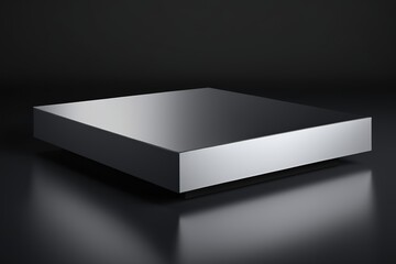 a close up of a shiny silver box on a black surface