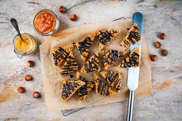 Homemade sheet pan hazelnuts cookie bar chips with roasted chopped hazelnuts chocolate glaze...