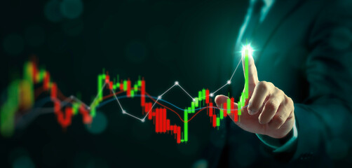 Businessman analyzing financial graphs on virtual screen. Business growth analysis and asset investment concept.