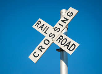 Railroad crossing cross sign for trains at roadway