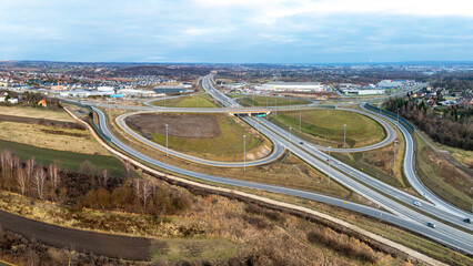 Modlnica interchange on S52, part of highway ring road around Krakow opened for  traffic on December 23, 2024. Multilevel junction with viaducts, enter and exit ramps. Aerial panorama