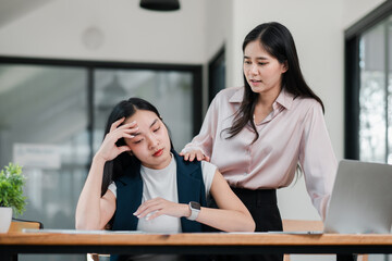 A concerned colleague offers support to a stressed coworker in a contemporary office setting,...
