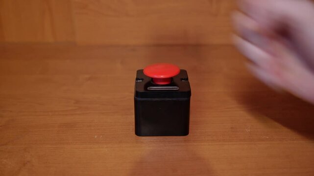 Pressing big red button with male hand. concept of the red button