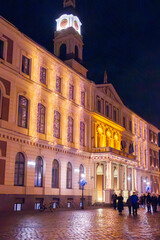 Riga, Latvia. Traditional Christmas Market On Dome Square With Cathedral. Famous Landmark In Winter Evening Night In Festive Illuminations Lighting