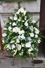 Funeral floral decorations with carnations, callas, eustomas and chrysanthemums.