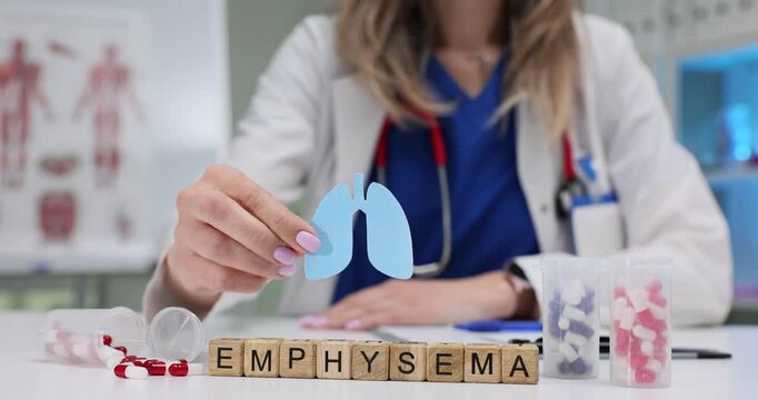 A dedicated healthcare professional is explaining the complex condition of emphysema using various models and blocks - Powered by Adobe