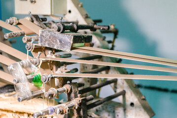 Glue machine for paper tube cores, steel metal engine, technology manufacturer in operation process in industry manufacturing plant factory. Raw product equipment. Cardboard cargo in warehouse