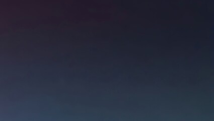 A blurred, grainy abstract background with a gradient from dark purple to light teal