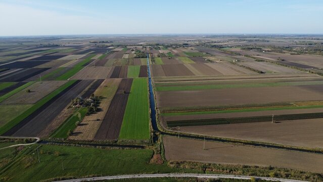 Aerial view of expansive farmland with patchwork fields.