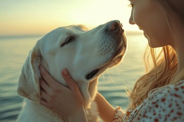 A woman is gently petting a fluffy white dog while at the beach