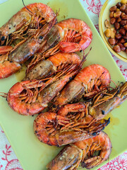 Top view of spanish dish prawns served on the tablecloth