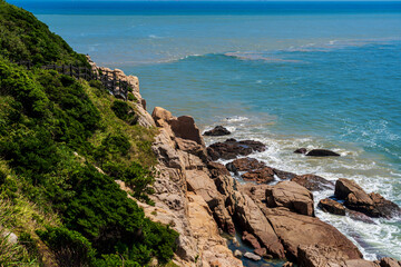 Serene Coastal View with Rocky Shores and Lush Greenery