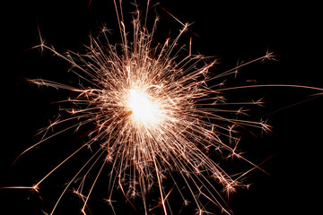 New Year's Eve celebration, sparkler spark in the darkness