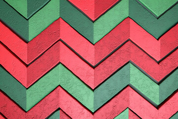 Abstract background with a bold green and red chevron stripes pattern, featuring geometric lines and zigzags, textured wall effect, designed with ample copy space for text, product overlay.
