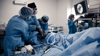 A close-up of professional surgeons performing the operation. Medical staff working in the hospital...
