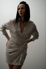 Woman in silver sparkly dress ready for evening party