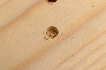 metal drill bit and pine wood board during operation