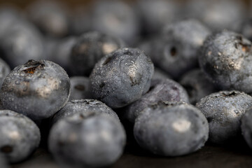 a pile of blueberries scattered on the board